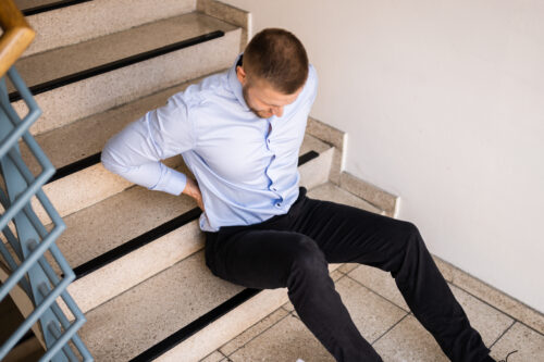 man fell down stairs sitting injured stairwell