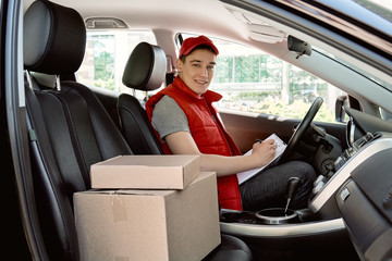man in car with packages
