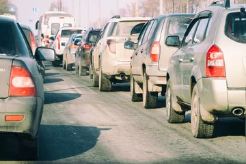 cars tailgating in bumper to bumper traffic