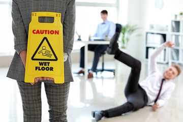 man on floor wet floor sign