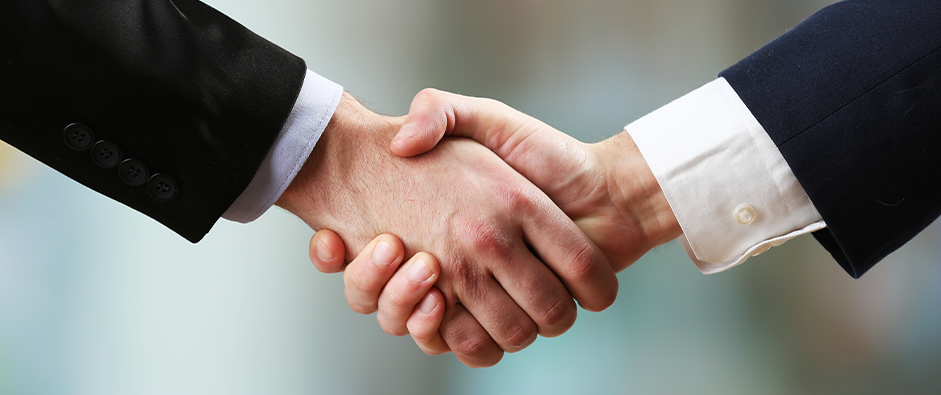 Business handshake on bright background