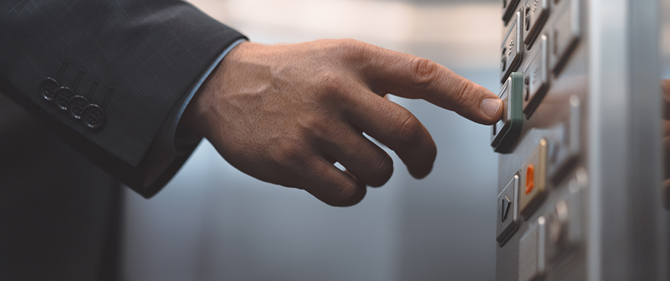 Man hand office worker in a business suit press the elevator button