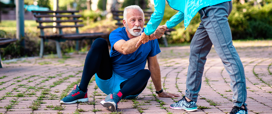 elderly man on ground after suffering a slip and fall accident in a park; Middlesex county NJ Premises Liability Attorneys concept image