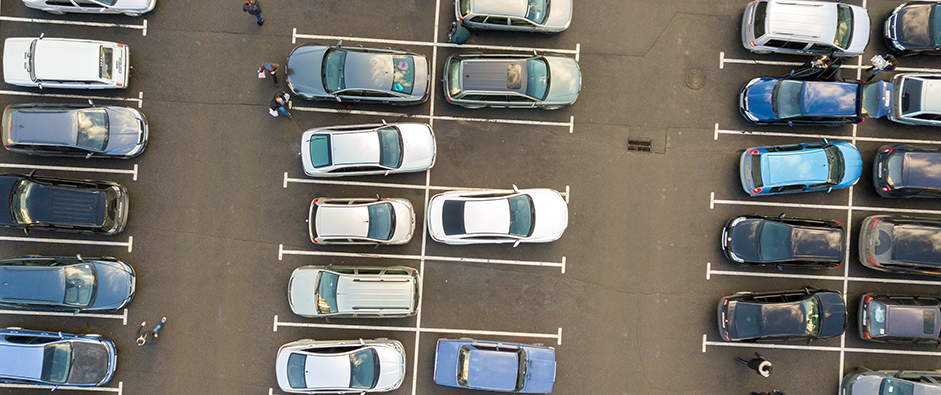 Top view of many cars parked on a parking lot