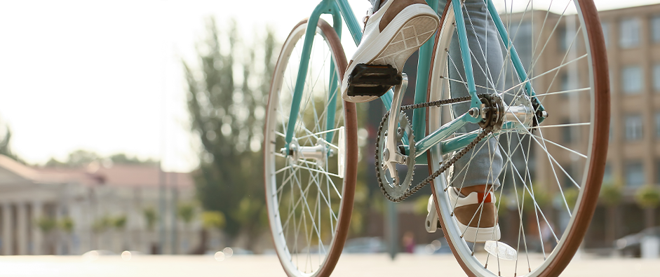 Young man riding bicycle on city square