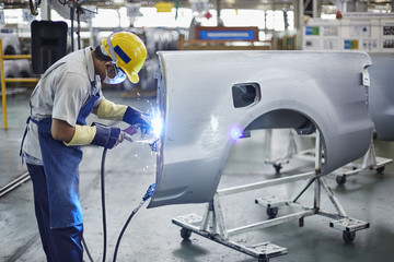 man working at car manufacturer