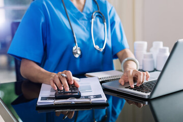 doctor calculating medical expenses