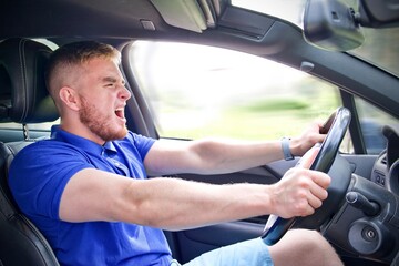 man driving car with scary look on his face
