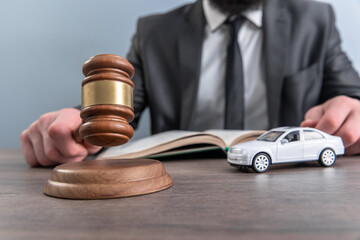 man with gavel and toy car