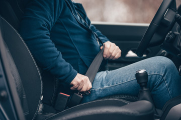 man buckling seatbelt