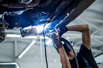 car manufacturer working on vehicle