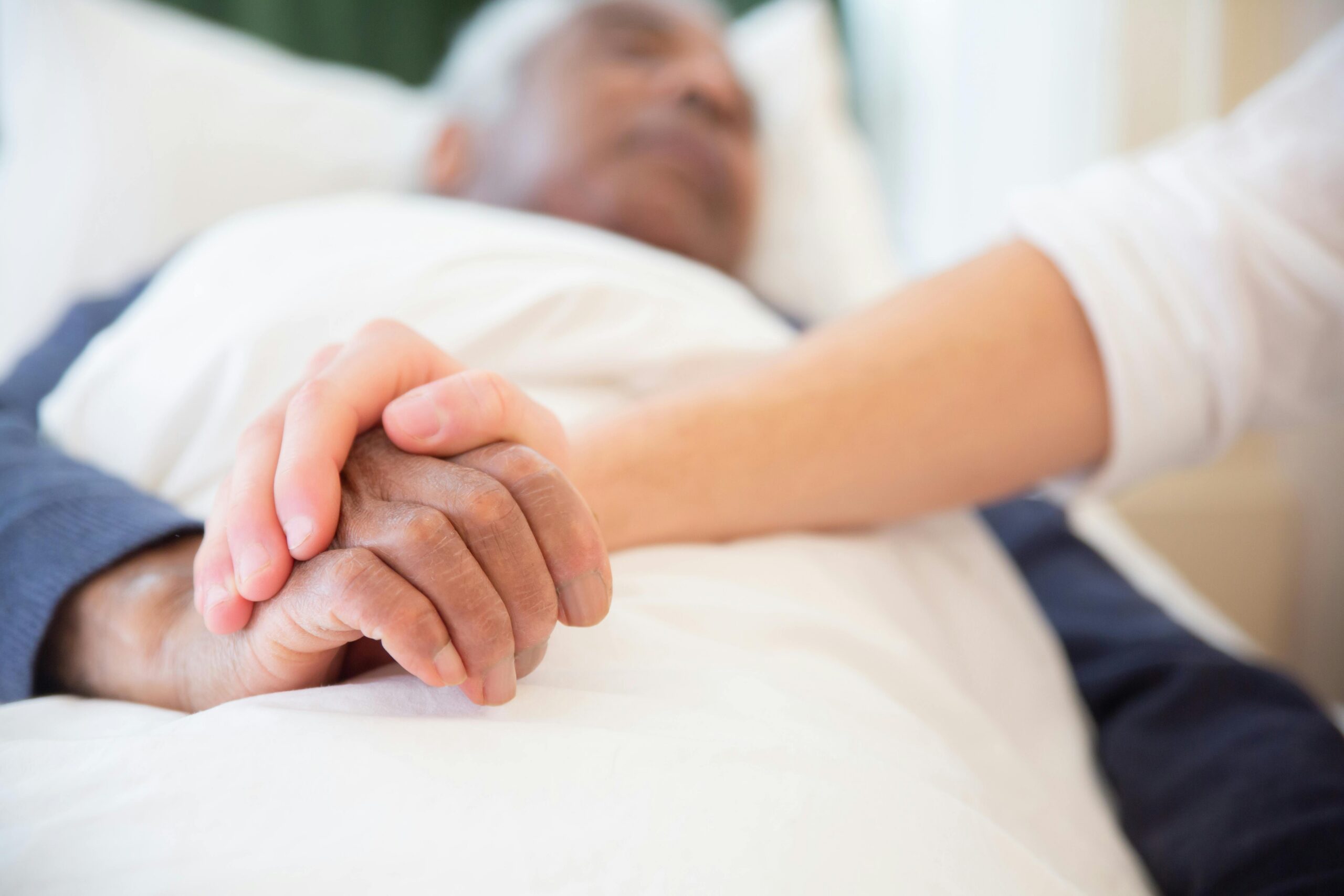 man in nursing home bed